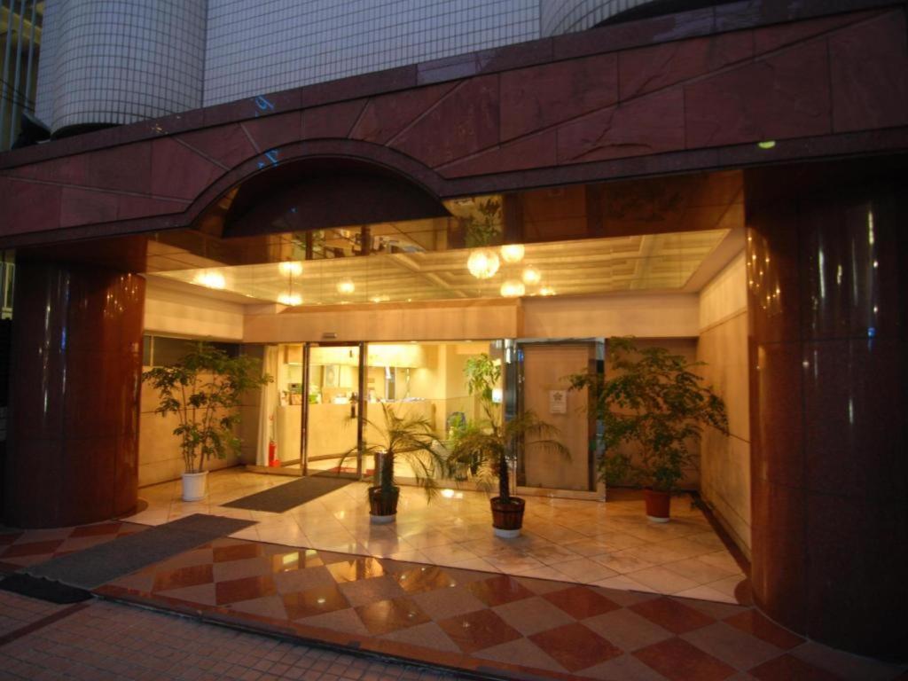 a lobby of a building with potted plants in it at Hotel Starplaza Ikebukuro in Tokyo