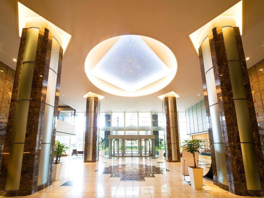 a large lobby with a large chandelier in a building at KKR Hotel Hakata in Susakiuramachi