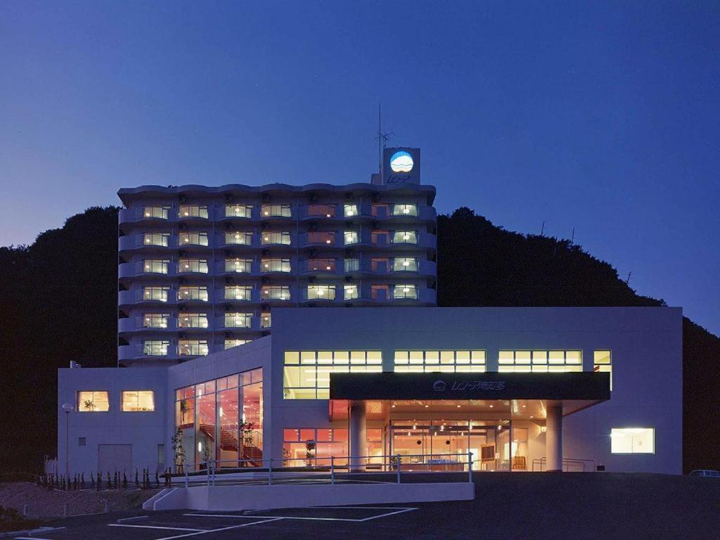 a large building with a clock on top of it at Hotel Resea Minamichita in Minamichita