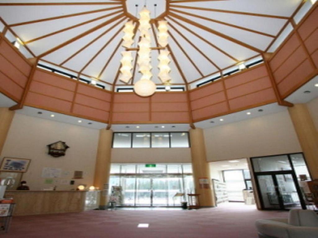 a large lobby with a large ceiling with a chandelier at Taichou no Mori in Ito