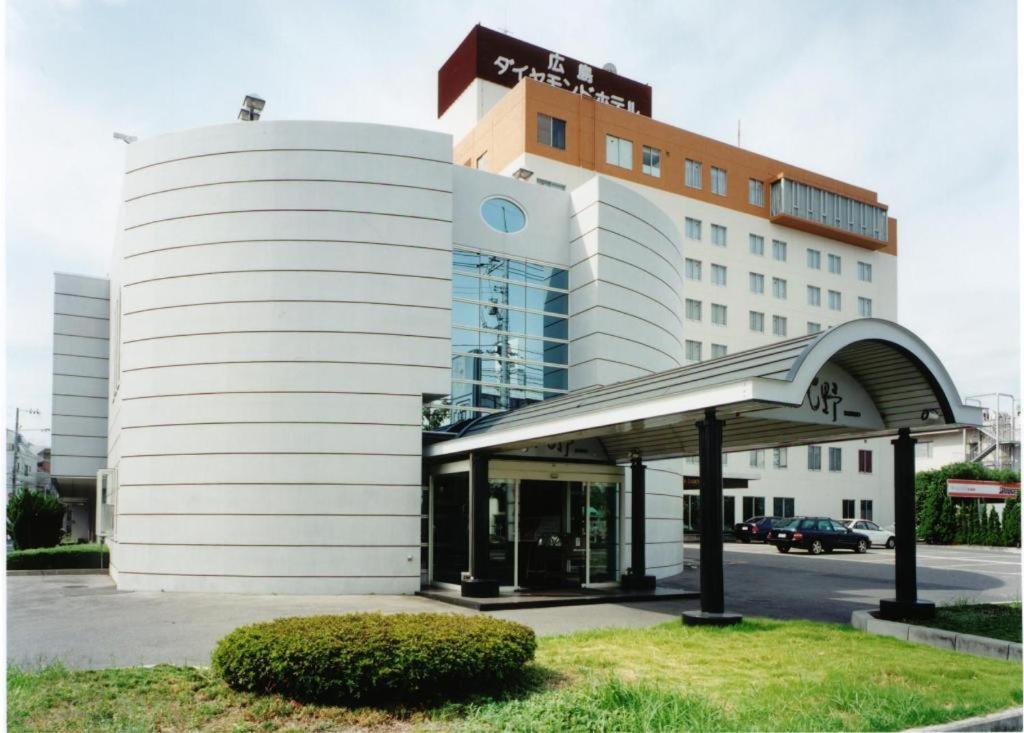 a white building with an entrance in front of it at Hiroshima Diamond Hotel in Minami-kannommachi