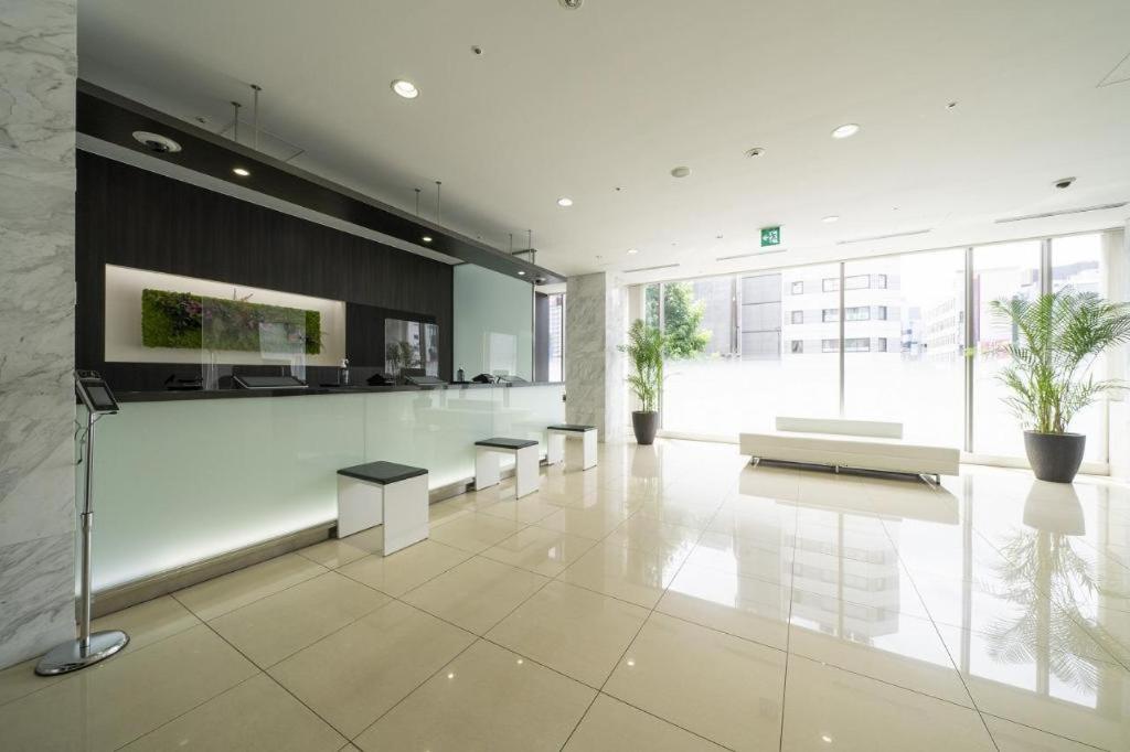 a large room with tables and benches in a building at Hotel Oriental Express Nagoya Sakae in Nagoya