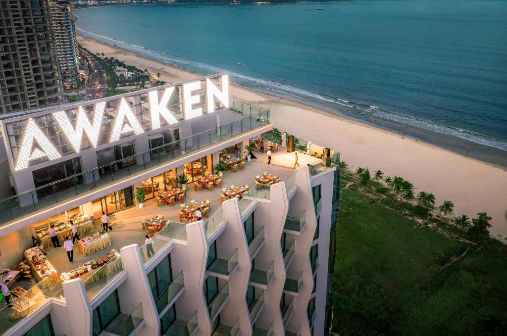 an aerial view of a building next to a beach at Awaken Da Nang Hotel in Danang