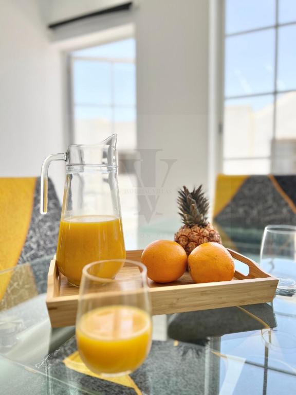 a tray of oranges and a jug of orange juice at Imperial Villas I Mar y Playa in Puerto del Carmen