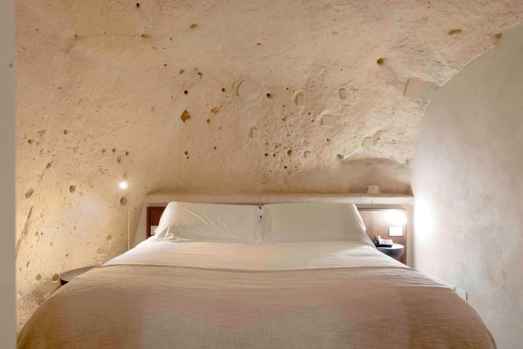 Postel nebo postele na pokoji v ubytování Sant'Angelo - Le Residenze
