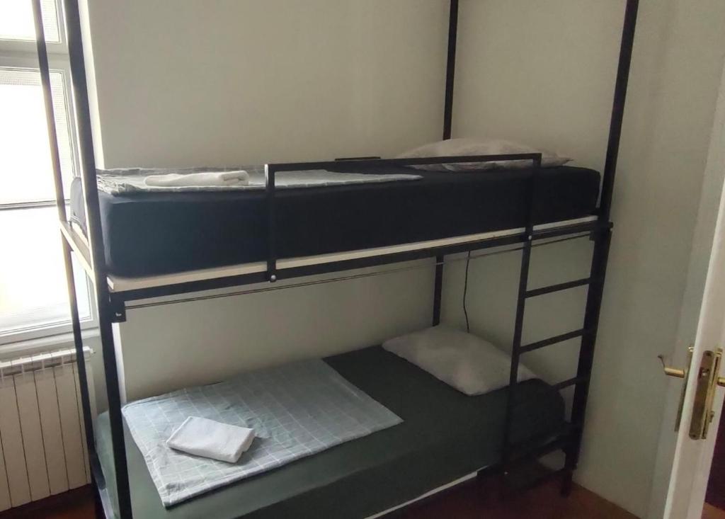 Rúm í herbergi á FG 1861 Hostel