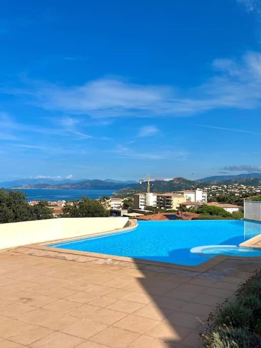 une grande piscine avec vue sur l'eau dans l'établissement Appartement vue mer avec piscine, à LʼÎle-Rousse