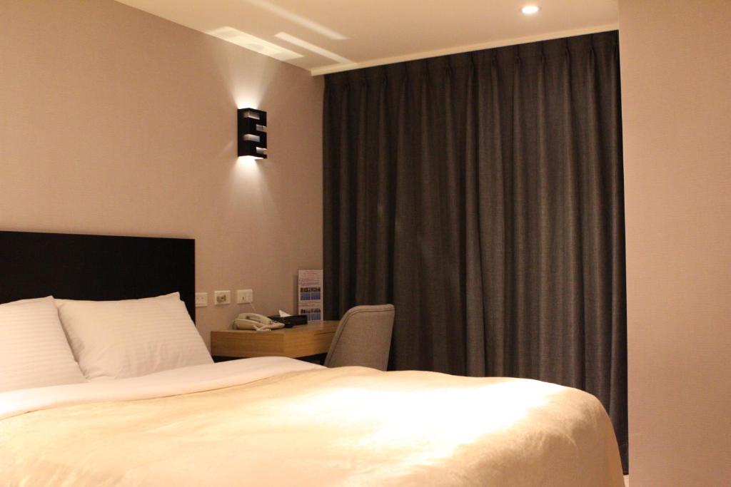 Postel nebo postele na pokoji v ubytování E-House Xining Branch