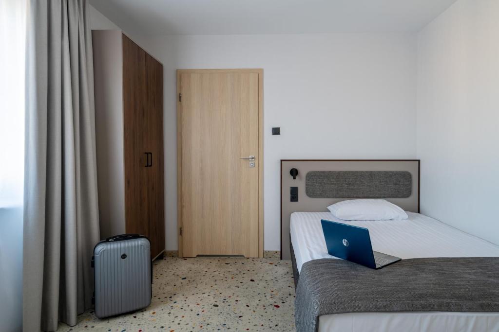 Postel nebo postele na pokoji v ubytování Antares Hotel