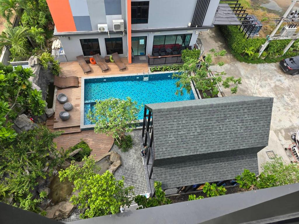 an aerial view of a house with a swimming pool at Bangkok Mystay Hotel Rangsit in Thanya Buri