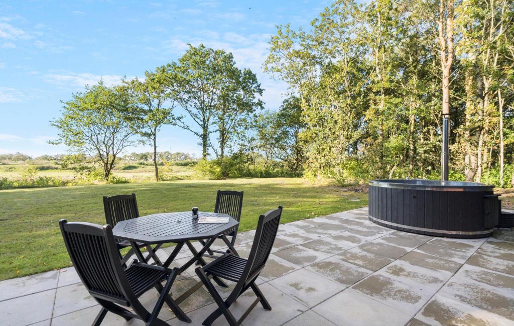 a patio with a table and chairs and a fire pit at 3 Bedroom Stunning Home In Skjern in Skjern