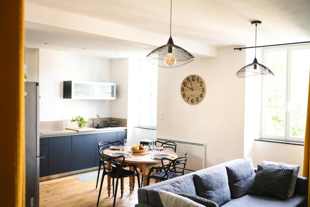 une cuisine et un salon avec une table et des chaises dans l'établissement Grand T3, plein centre, à Bagnères-de-Bigorre