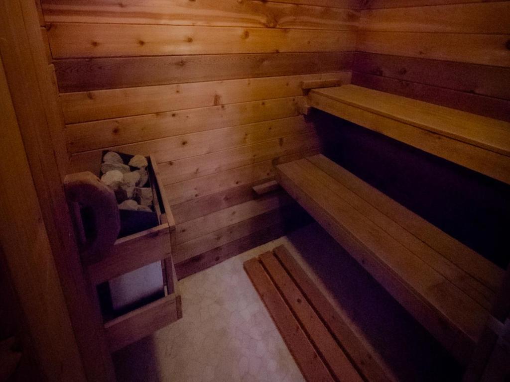 an empty sauna with wooden walls and wooden floors at Riverside Retreat with Sauna & Hot Tub in Elora in Elora