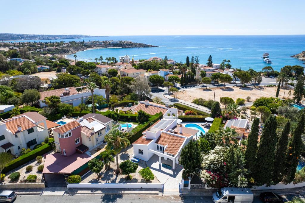 an aerial view of a house and the ocean at Ivy Blue Villa by Nomads - Short Walk to Coral Bay in Peyia