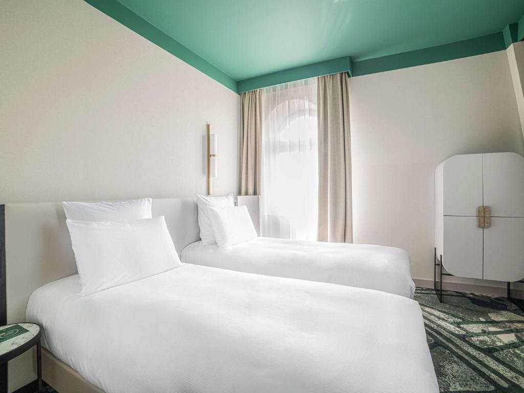 Łóżko lub łóżka w pokoju w obiekcie Rezydent Hotel Sopot - MGallery Collection