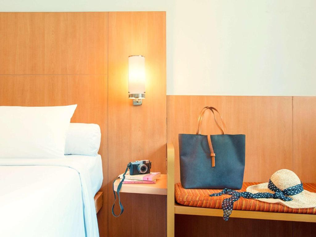 Postel nebo postele na pokoji v ubytování Ibis Bali Kuta
