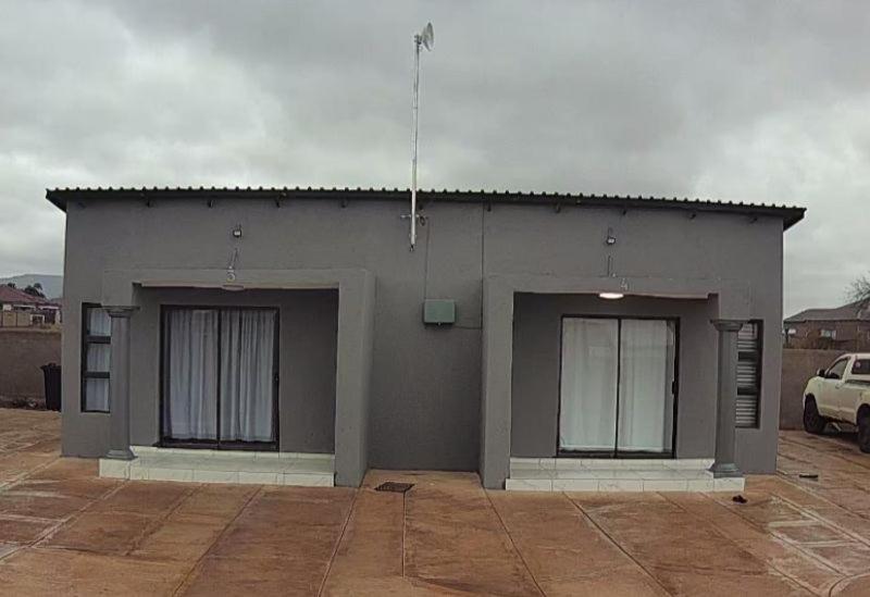 a small gray building with two windows on it at Mukutsuri Luxury Apartments in Giyani