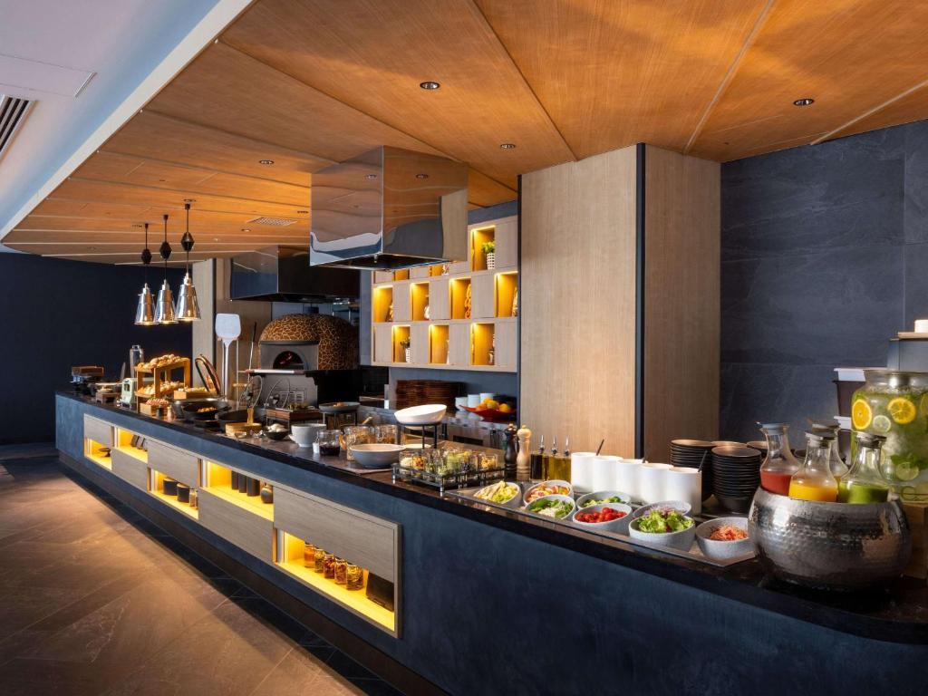 a kitchen with a buffet with food on it at Novotel Nara in Nara