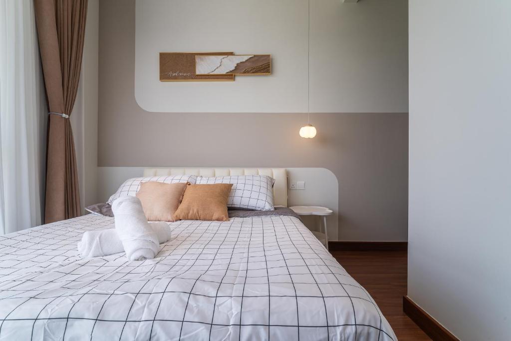 a bedroom with a bed with a white comforter at Setia Alam Convention Centre 3 Bedroom 2-9Pax #33 in Shah Alam
