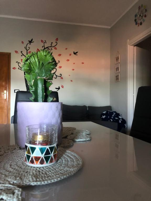 a table with a potted plant in a living room at La Casa di Pablo B&B in Ferrara