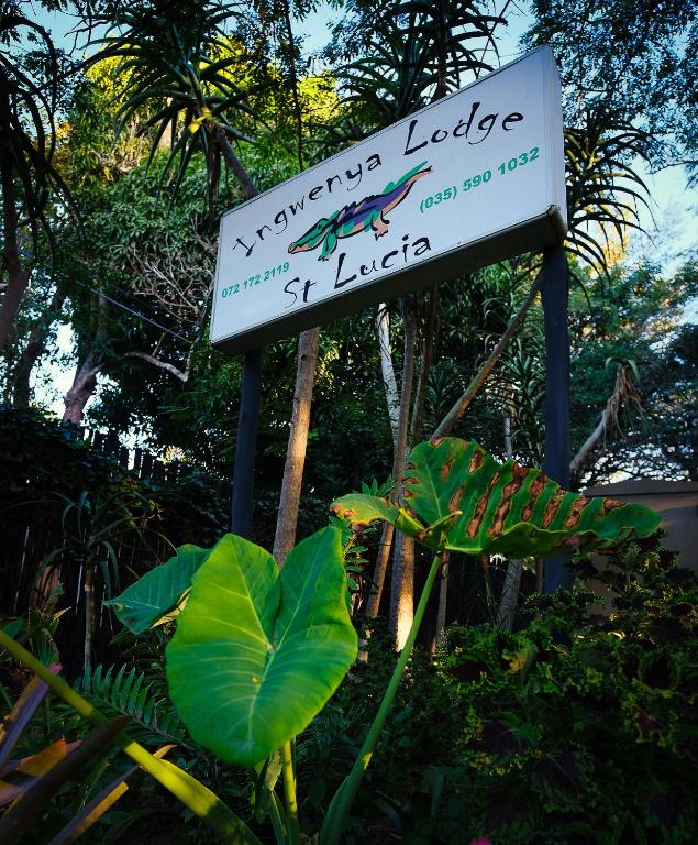 a sign for a tropical lodge with a lizard on it at Ingwenya Lodge in St Lucia