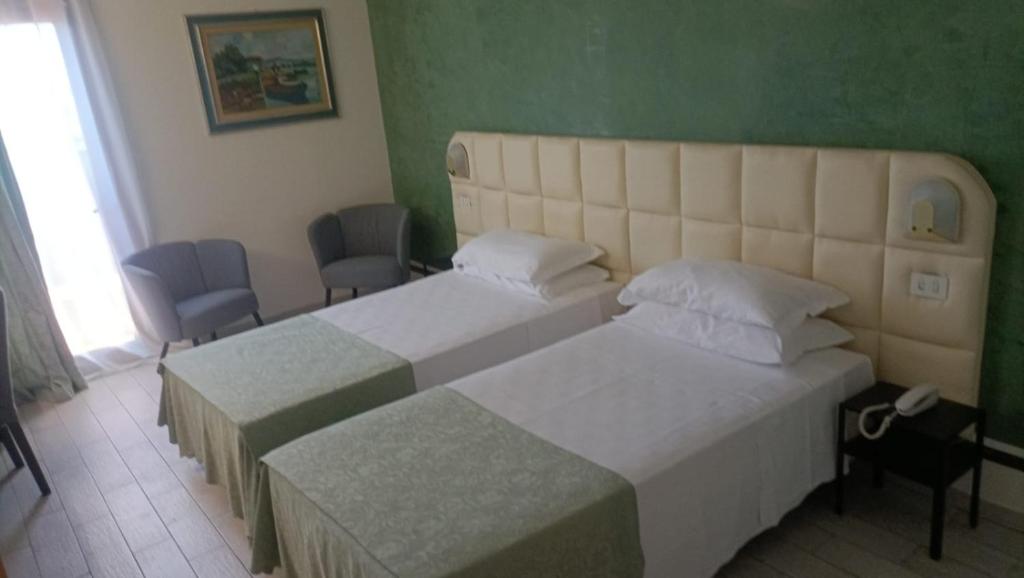 Postel nebo postele na pokoji v ubytování Hotel Delta Florence