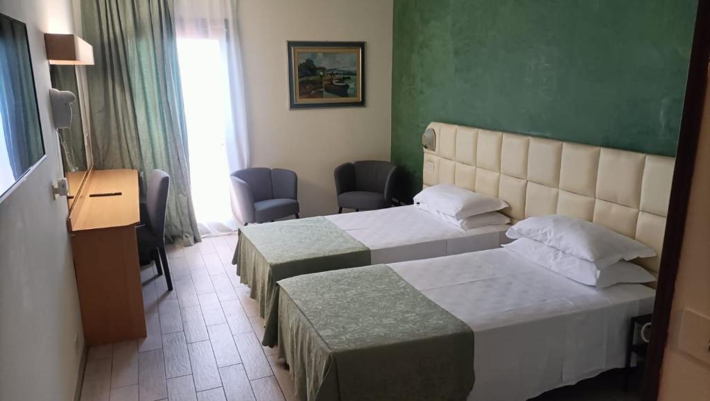 Postel nebo postele na pokoji v ubytování Hotel Delta Florence