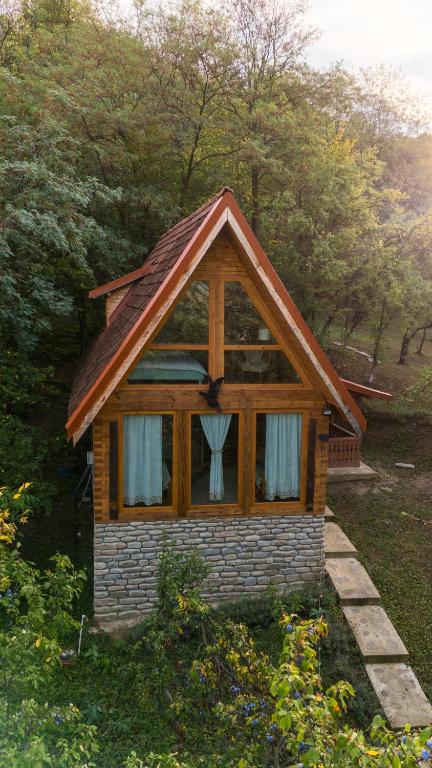 a small house with a window in the grass at La sat - Blândă Mărie in Bertea