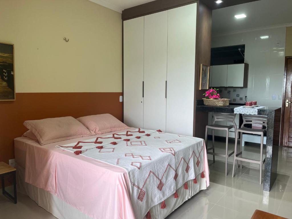 a bedroom with a large bed and a desk at Flat Ilha Bela 22525 in Alter do Chao