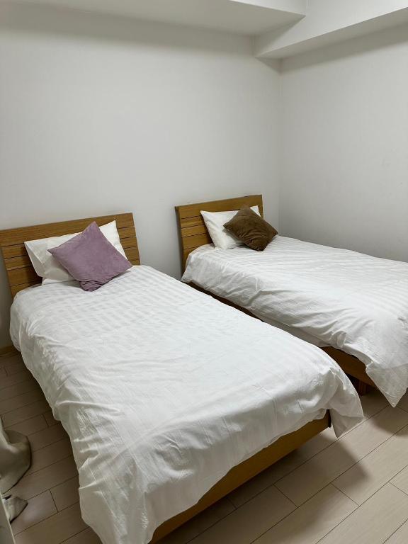 Postel nebo postele na pokoji v ubytování Residence天王寺東