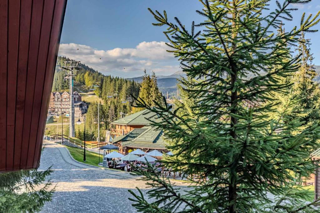 a christmas tree on the side of a road at Bukovel Hotel in Bukovel