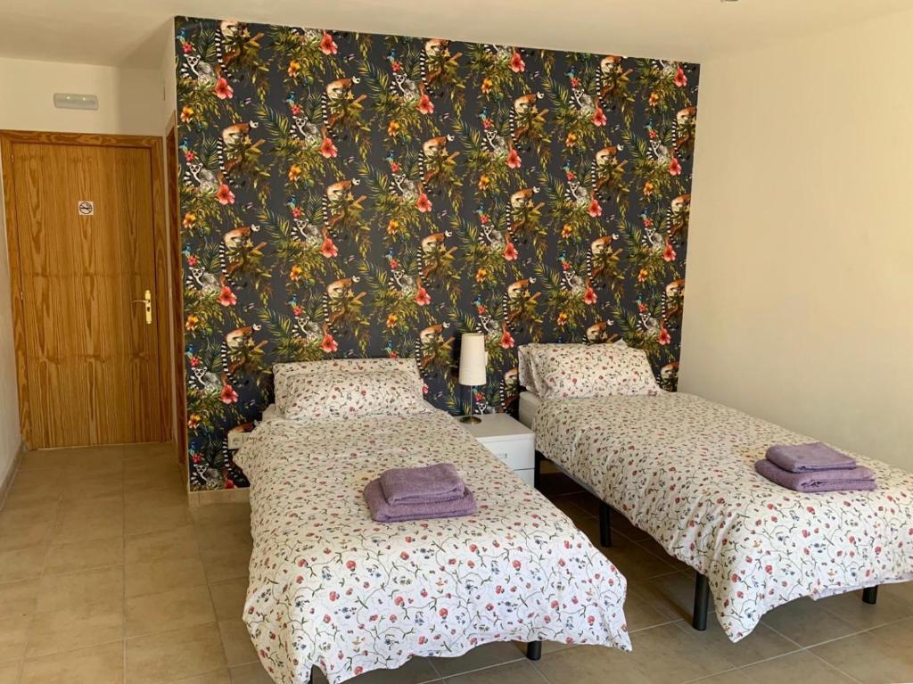Cama o camas de una habitación en Hostal Casa Michaels