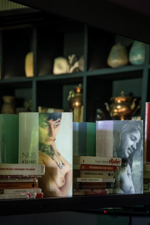 a group of books sitting on a shelf at Hôtel Ville d'Hiver in Arcachon