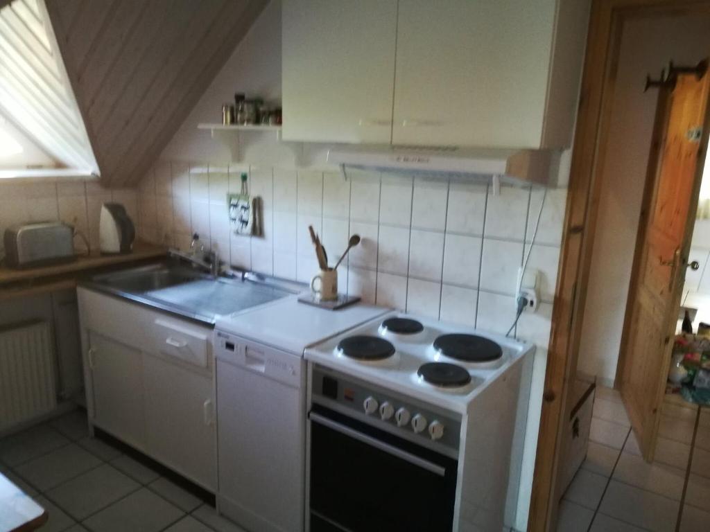 a kitchen with a white stove and a sink at Ferienwohnung Seeblick in Plau am See