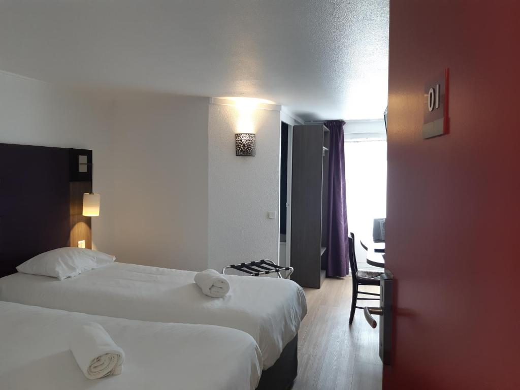 Postel nebo postele na pokoji v ubytování Brit Hotel Reims La Neuvillette