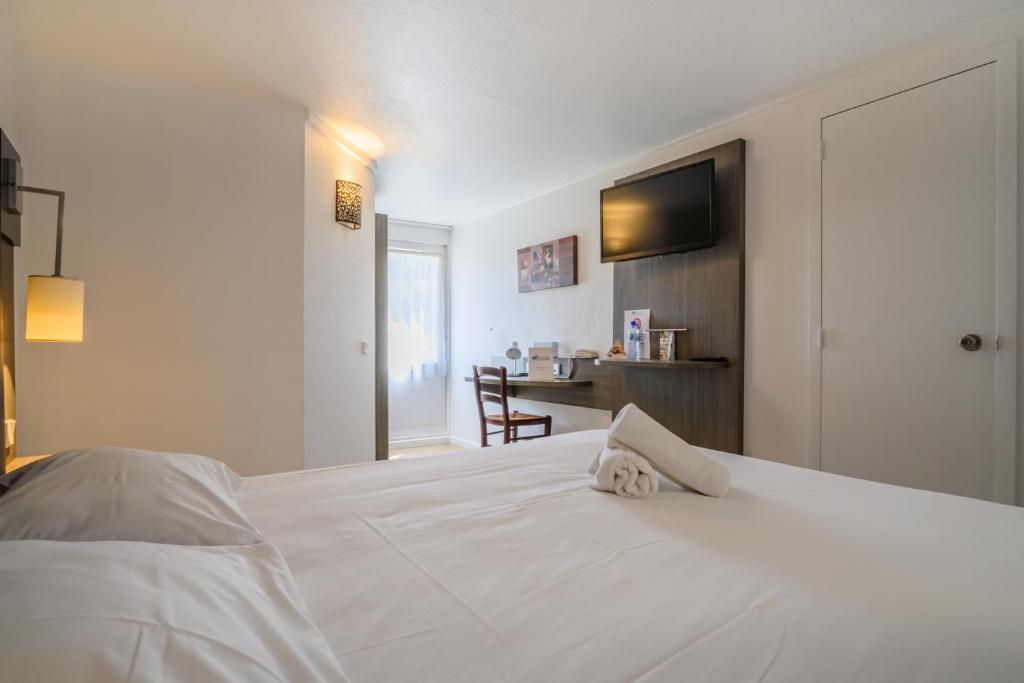 Postel nebo postele na pokoji v ubytování Brit Hotel Reims La Neuvillette