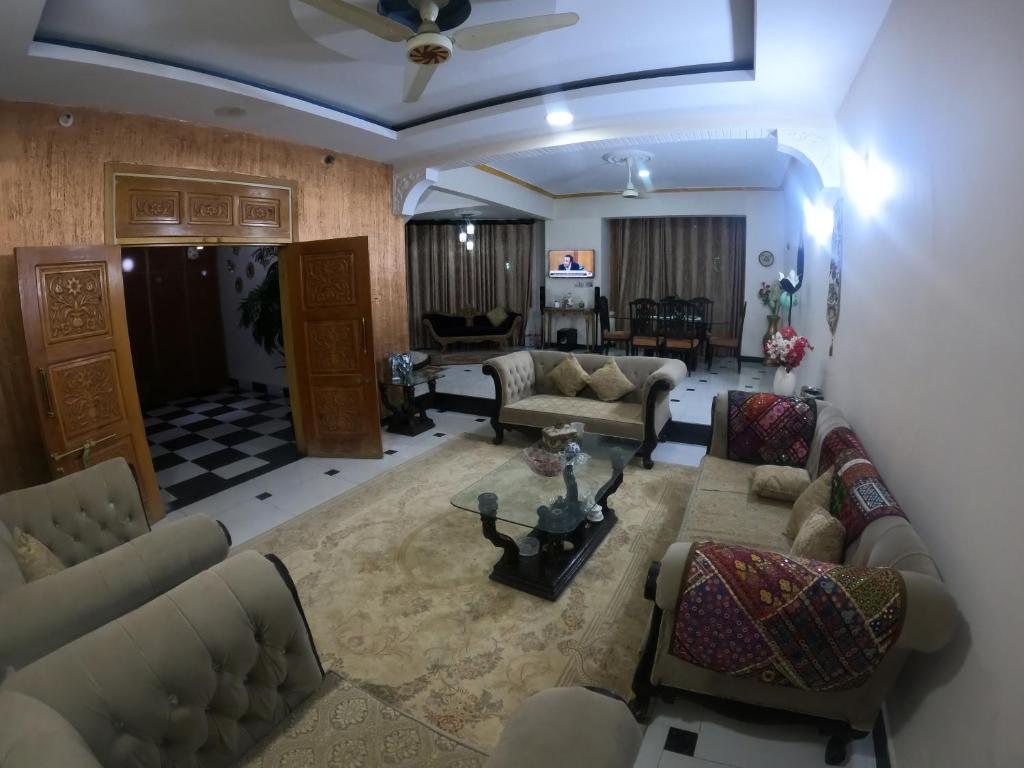 an aerial view of a living room with couches at Kashmir Cottage Muzaffarabad in Muzaffarabad