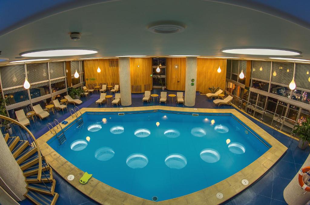 a large swimming pool in a hotel room at Grand Hotel Bucharest in Bucharest
