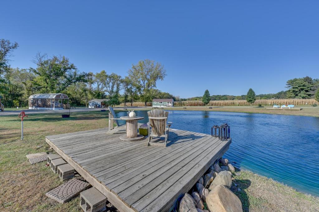 a wooden dock with a table and chairs next to the water at Steamboat Rock Cabin Near Trails and River! in Steamboat Rock