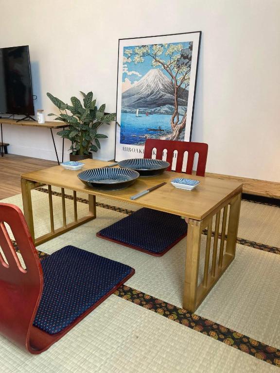 une table et des chaises en bois dans un salon dans l'établissement La Japan House, au Mans