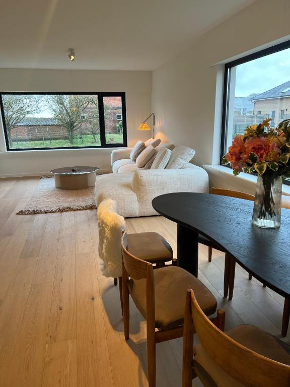 a living room with a couch and a table at Maison Olive in Torhout