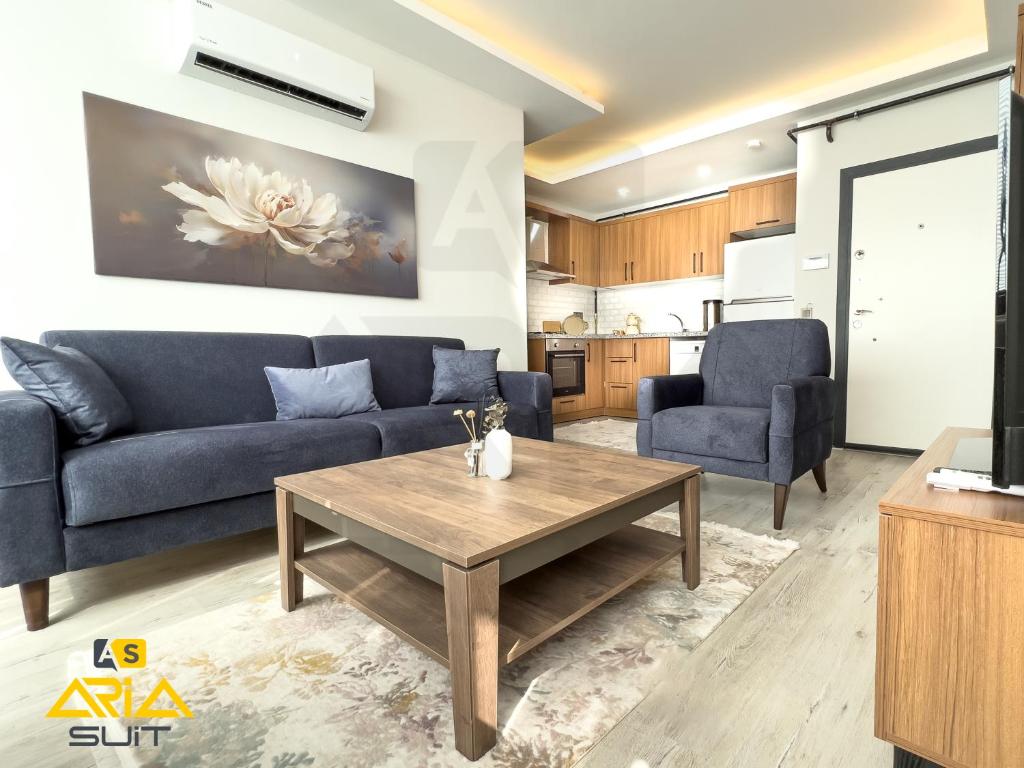 a living room with a couch and a table at Aria Suit in Mezitli