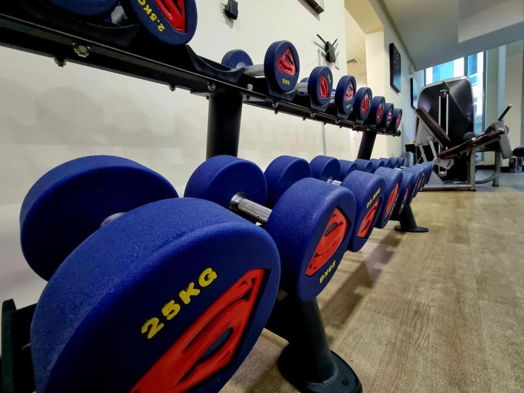 a row of blue boxing machines in a gym at Aspire Tower # Serenity Suite Juffair in Manama