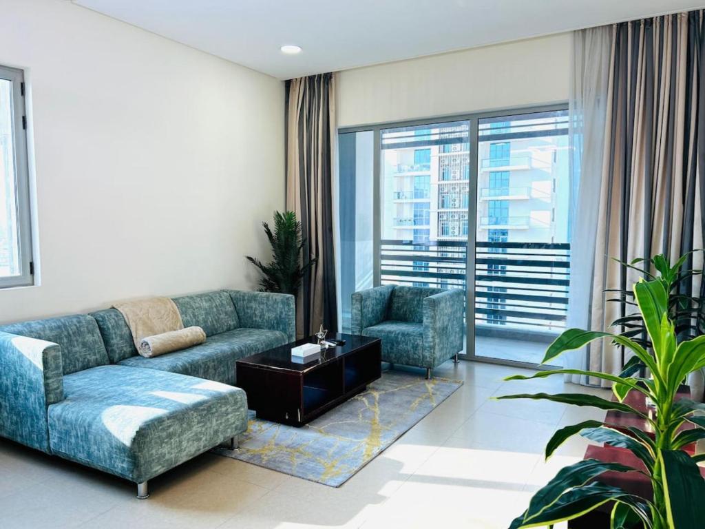 a living room with a couch and two chairs at Aspire Tower-The Tranquil Haven in Manama