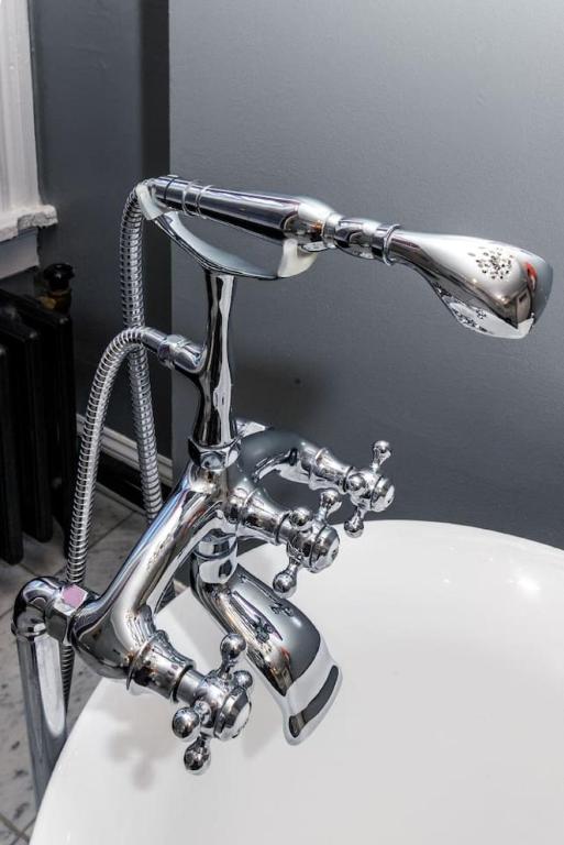 a bathroom sink with a faucet on top of it at Luxury Brownstone - Walk to ALL - Washington Park in Cincinnati
