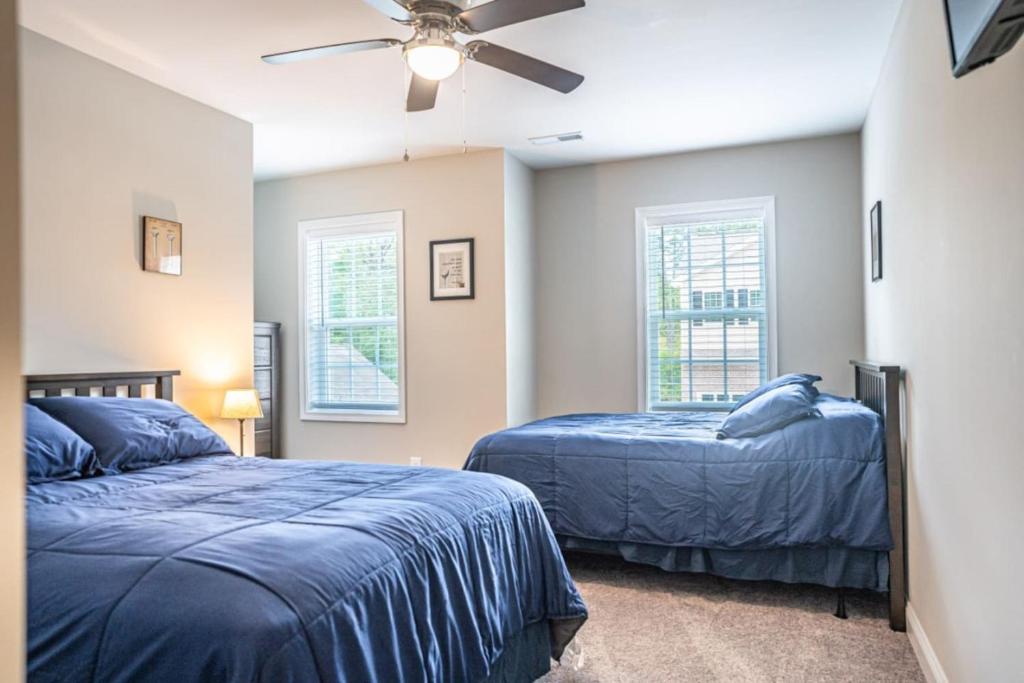 a bedroom with two beds and a ceiling fan at The Magnolia at Ducks Landing in Aberdeen