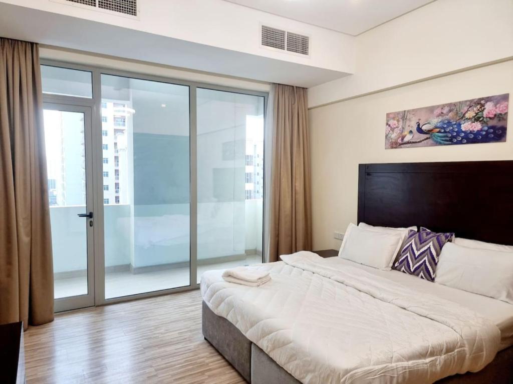 a bedroom with a large bed and a large window at Aspire Tower # 10th Floor Aspire Tower Paradise in Manama