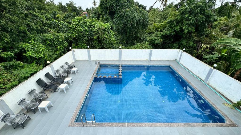 a swimming pool on top of a house at Golden Pearl Resort By Gemstone Hospitality in Alibag