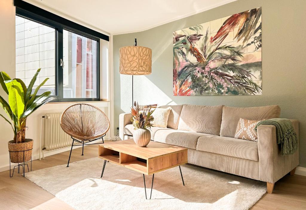 a living room with a couch and a coffee table at I Zentral l Kingsizebetten l nähe HBF und Dom in Aachen