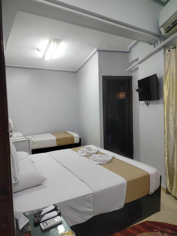 Postel nebo postele na pokoji v ubytování Abo Elwafa Hotel